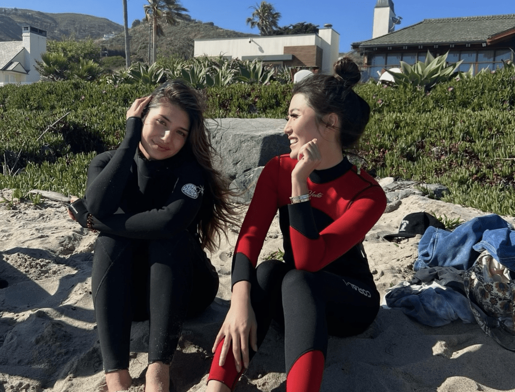 Sabrina Canario (left), owner of LikeAFriendSaid, sits at the beach with her friend at one of the organized beach events in Malibu. She said that due to Malibu regulations, it cost her money out of her own pocket to hold this event at Zuma beach. Photo courtesy of Sabrina Canario